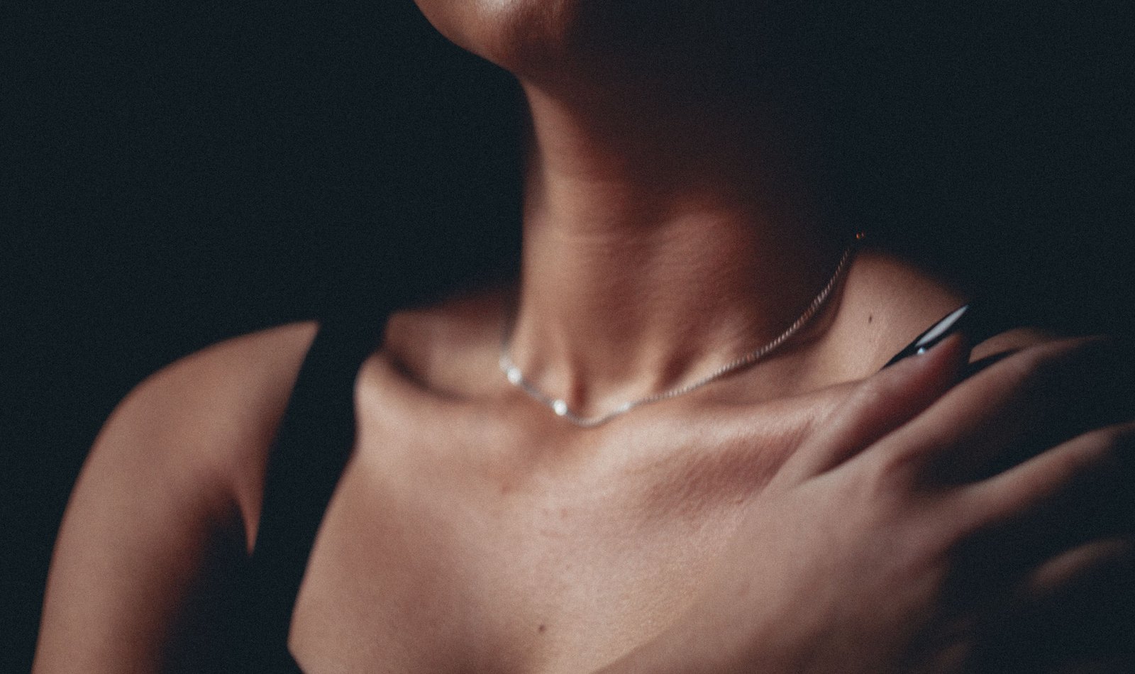 Shoulder and collarbone in low, warm light